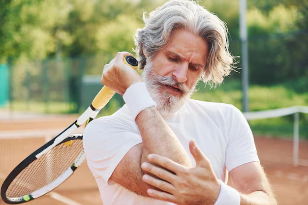 Athlete on a sports field experiencing pain after a training session — sports chiropractic Oakland