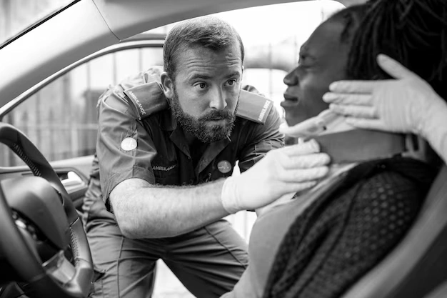 Paramedic placing a cervical collar on a woman injured in a car accident — auto accident care in Oakland